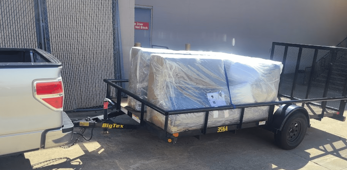 Truck moving wrapped furniture in trailor